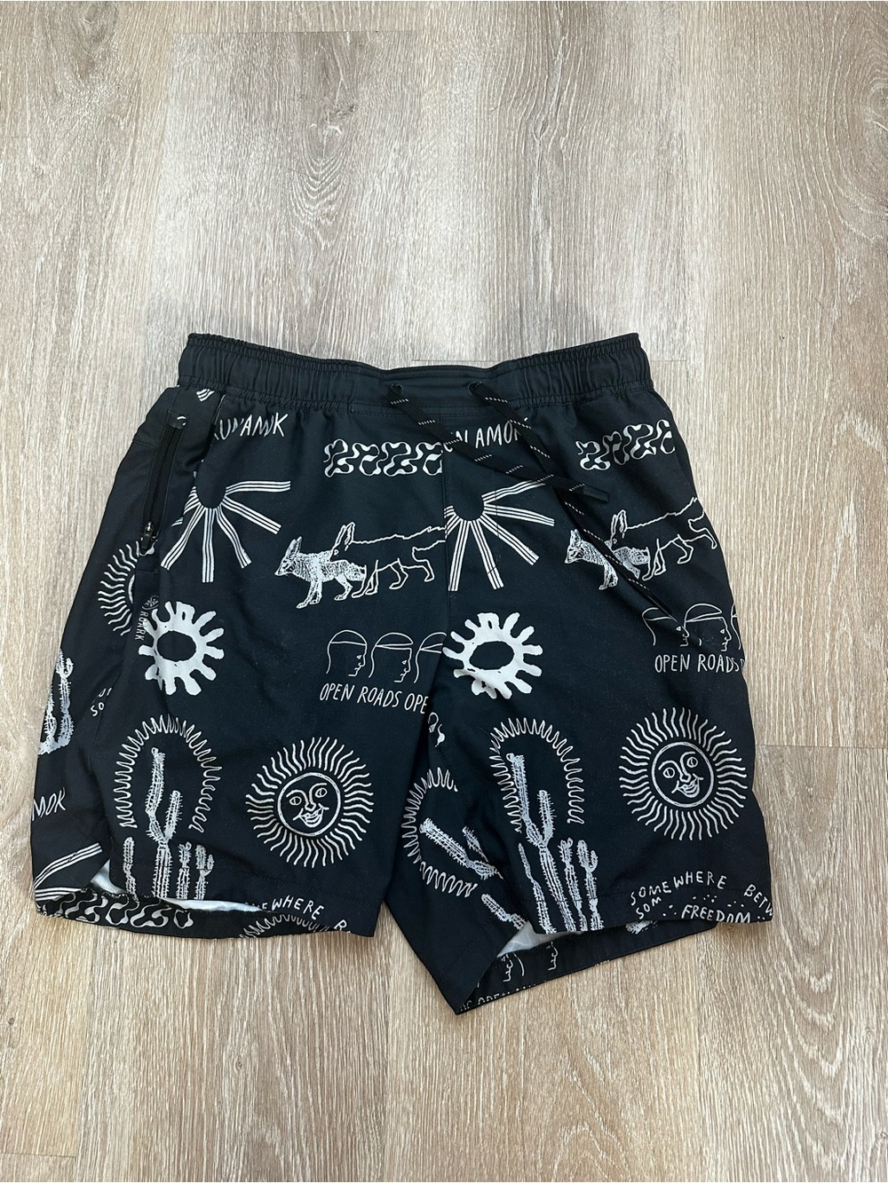 Roark Bommer 7” Linerless Black Swim Shorts with White Graphic Desert Print